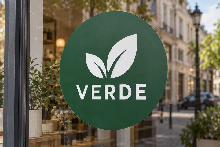 Round green logo window sticker on a shop window